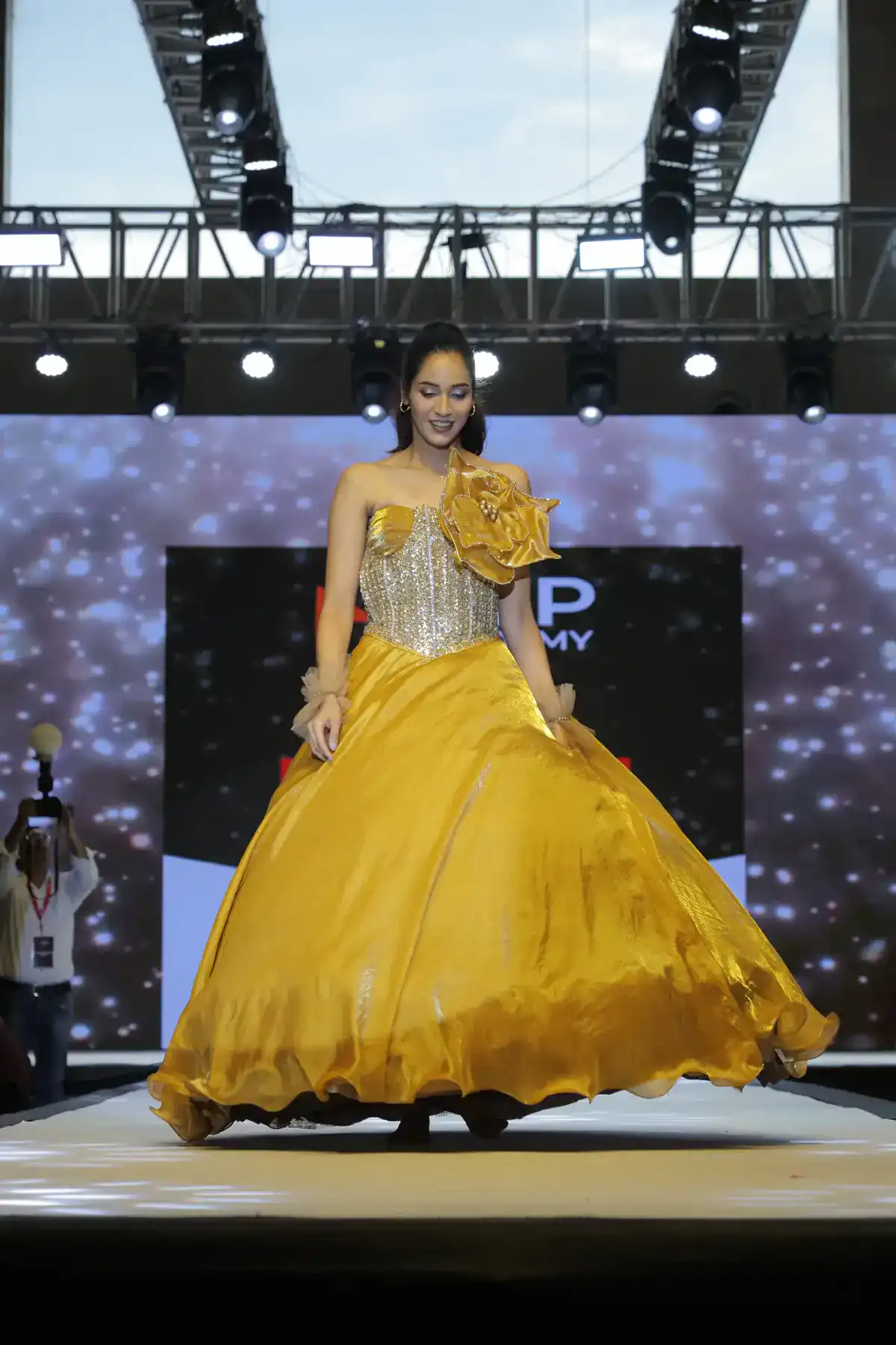 Meraki 2026 — golden couture gown on the runway
